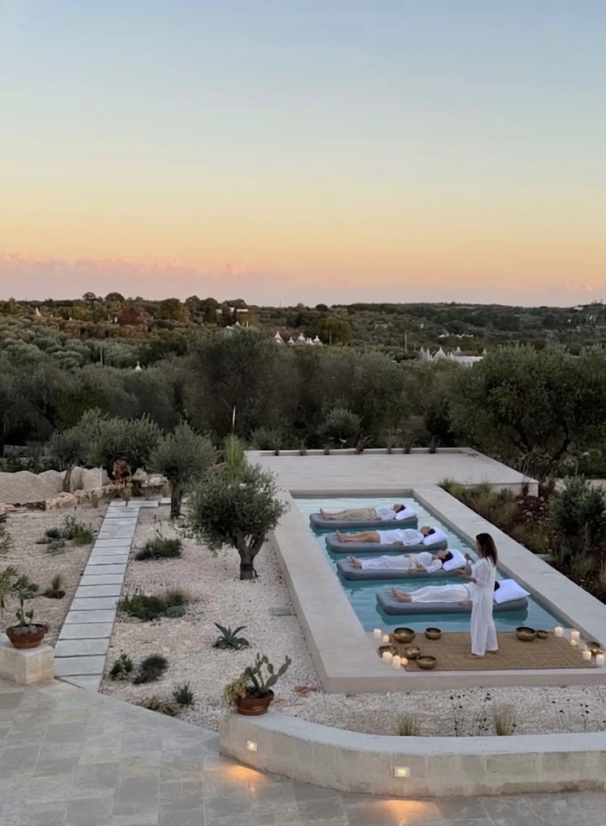 Floating sound bath in the pool at dusk